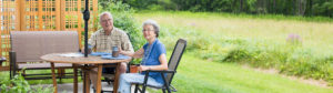 two residents sitting at a table on patio